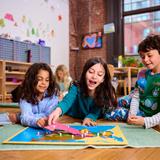 Kingsley Montessori School Photo - Elementary students exploring a geography work. A key component of the Kingsley mission is raising empathetic global citizens-students who care deeply for the world and work together to improve it.