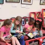 Las Cruces Academy Photo - Kindergarteners diving into new books at our in-house book fair