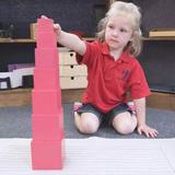 St. John The Baptist Catholic Montessori School Photo - Children's House student with the Pink Tower