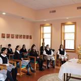 Villa Maria Academy Photo - 2nd-grade students practicing for the Sacrament of Communion with Father Pergjini in the chapel of the convent located right on campus.