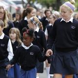 Visitation School Photo - Middle School students escort Lower Schoolers to the school opening flag raising in September.